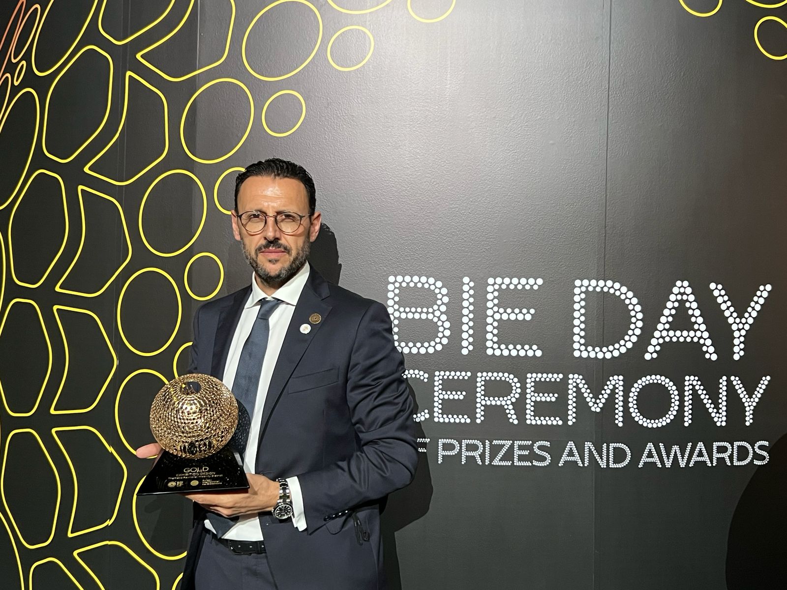 Giuseppe Di Nicola holding gold award in interior design at Holy See Pavilion at Dubai Expo 2020
