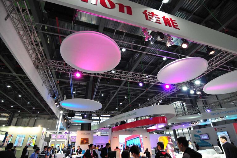 Custom exhibition elements and lighting details within the Canon stand.